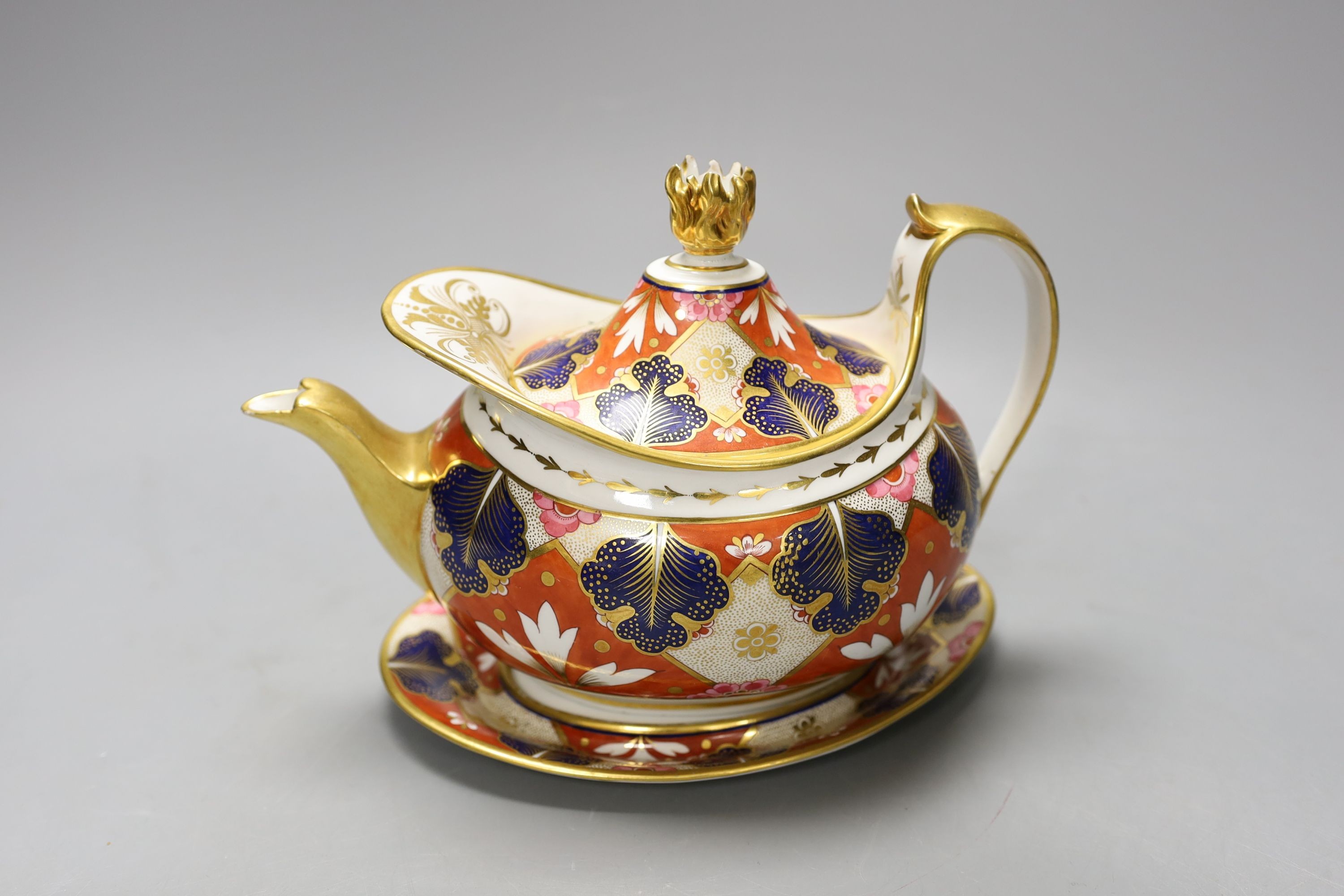 A Barr Flight and Barr Worcester teapot cover and stand painted with an Imari pattern, c.1805, 23 cm long